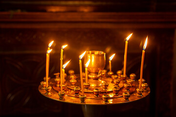 Obraz premium Many burning wax candles in the orthodox church or temple