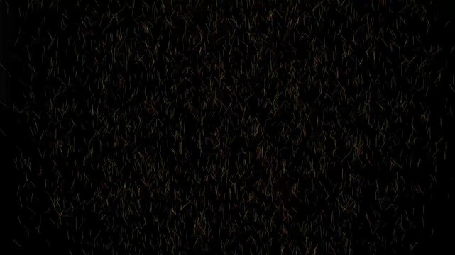 A dense scattering of thin, short, multi-colored lines resembling confetti or abstract particles drifting against a dark black background