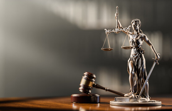 Legal Concept: Themis is the goddess of justice and the judge's gavel hammer as a symbol of law and order on the background of books