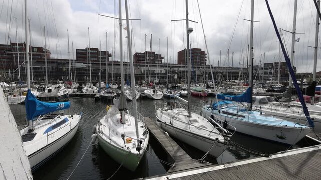 View opens from pier to marina basin with moored boats in harbor