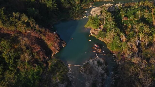 A cinematic aerial view of the Oya Valley in Kedungjati, a tranquil and clean river and canoeing destination. Located in Sriharjo, Bantul, Indonesia.