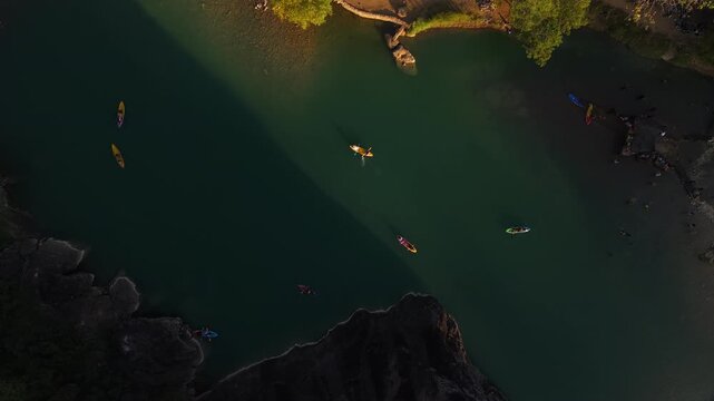 A cinematic aerial view of the Oya Valley in Kedungjati, a tranquil and clean river and canoeing destination. Located in Sriharjo, Bantul, Indonesia.