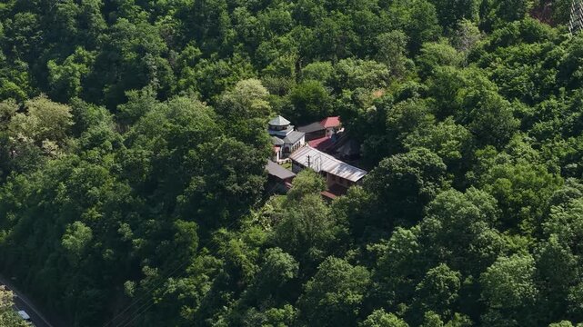 Drone Shot of Orthodox Monastery in Forest Above Ovcar Banja, Serbia