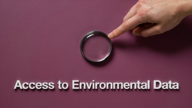 Close up of a human hand pointing at a magnifying glass to symbolize the search for environmental data and scientific research