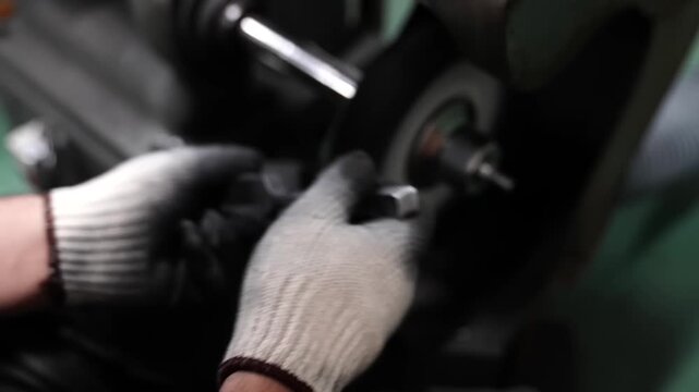 Craftsman polishing stainless steel fork tines on rotating buffing wheel achieving mirror finish