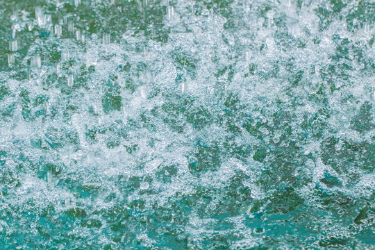 Close-up of a waterfall flowing into a forest pond
