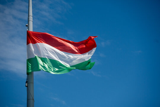 Hungarian National Flag Waving in Blue Sky
