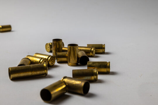 Empty Brass Bullet Casings on White Background