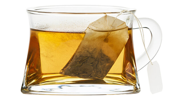 Glass mug with amber tea and tea bag