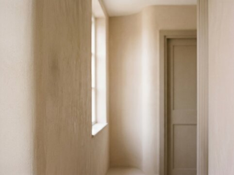 Modern empty hallway with natural light and minimalist design. Neutral-toned interior corridor featuring soft illumination and clean architectural...