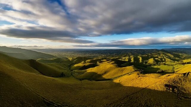 Rolling hills timelapse cloud shadows drift across slopes light transitions softly over