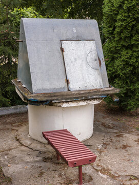 Traditional water well with a concrete base and metal roof
