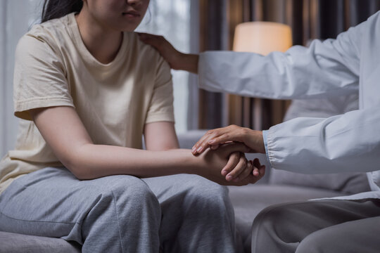 Female psychologist comforting and encouraging a teenage girl with depression during a counseling session, mental health, therapy, emotional support, recovery, healthcare, empathy, hope.