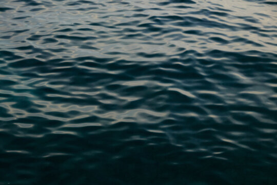Dark blue rippled ocean water surface blurred texture background
