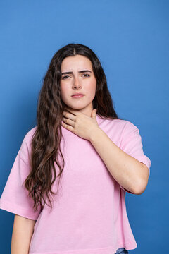Young woman suffering from sore throat pain