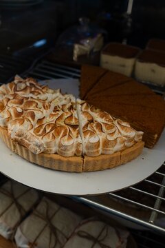 Lemon meringue tart and cake on bakery display
