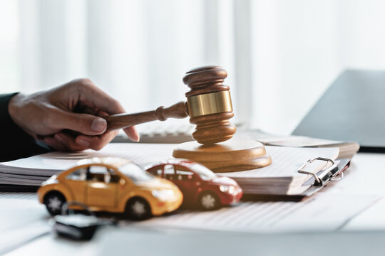 Lawyer with gavels in traffic court to judge and punish offenders in car accident cases involving claims for damages and liability.