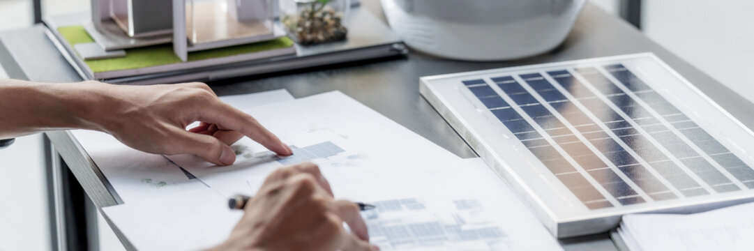 Business man designs green electricity plans in eco friendly office environment
