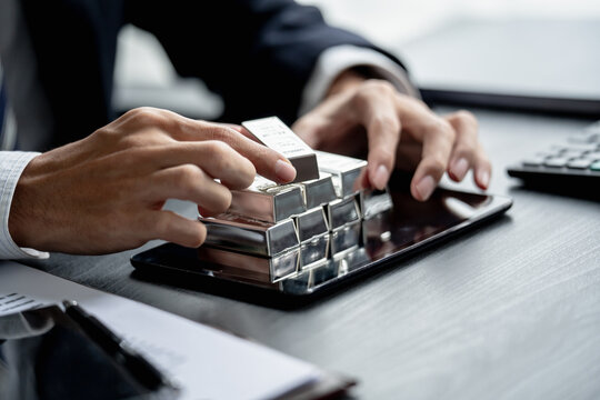 Businessman assesses silver commodity for investment strategy