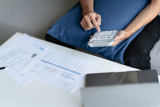 male calculating personal financial for future plan at his home, taxes payment