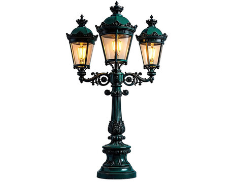 An ornate, three-headed street lamp with a dark green finish stands illuminated against a black background.