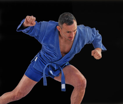 Martial arts fighter training wearing blue kimono.
