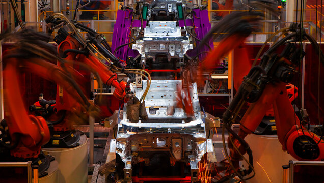 Automated production line with robotic arms in automobile manufacturing plants