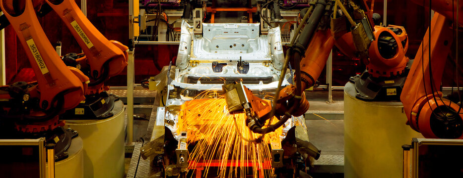 Automated production line with robotic arms in automobile manufacturing plants