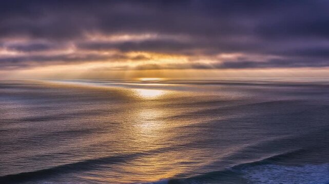 Sunset loop ocean ripples reflect golden light sky fading into violet tones serene view