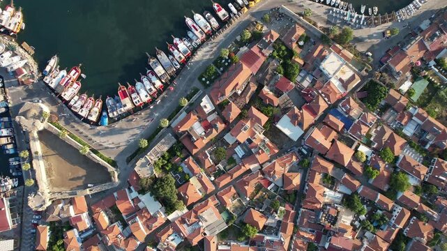 Aerial view flying over the scenic coastal town of Sigacik, with boats moored in the harbor,fa01