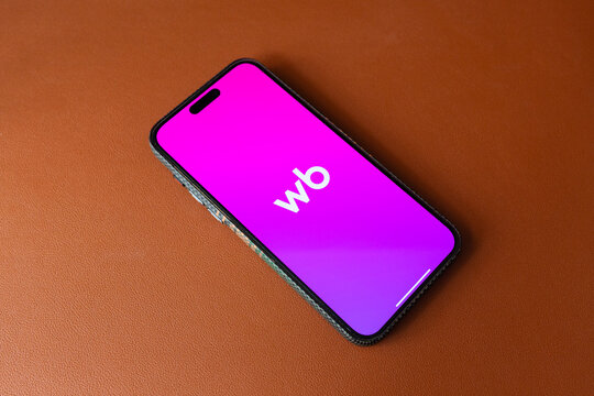 Yerevan, Armenia - 07.20.2026: Mobile phone displaying the Wildberries WB application logo on screen placed on brown leather background Wildberries russian Marketplace