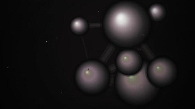 A cluster of metallic spheres connected by rods floats against a dark background with scattered light reflections.