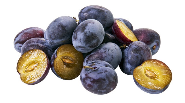 Pile of fresh ripe plums some whole, some halved showing juicy yellow flesh and pit