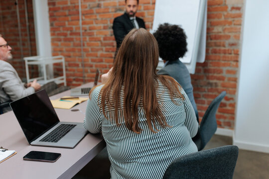Business professionals attending a corporate meeting presentation
