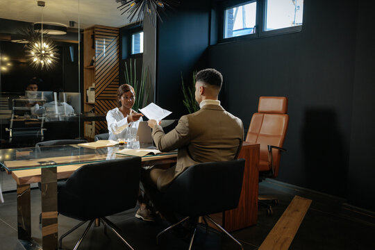 HR manager offering documents to job applicant