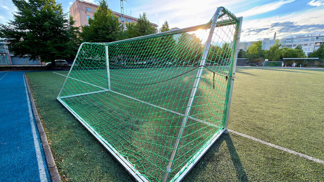 Soccer Goal with Green Net on Artificial Turf Field at Sunset