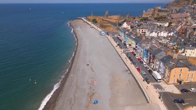 Aberystwyth pebble beach promenade seafront and castle ruins aerial view