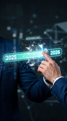 Obraz premium Hand touching a digital interface transitioning from 2025 to 2026, symbolizing progress and future planning
