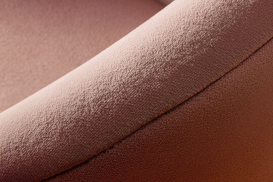 Muted pink velour fabric texture close up curve background