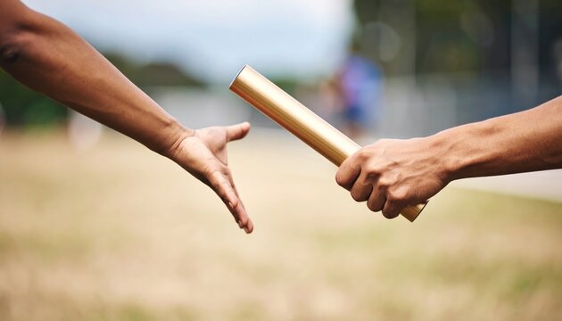 Close up of athletes hands exchanging a gold relay baton during a sports race on a track, symbolizing teamwork, transition, and athletic competition.