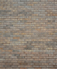 Fototapeta premium Vertical close-up view of a multi toned light brown brick wall surface with porous, rough, uneven bricks and smooth porous mortar joints forming the wall structure