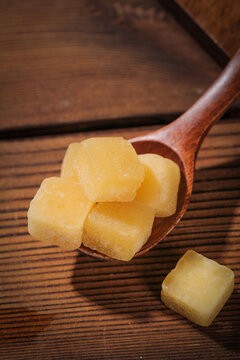 Yellow Fruit Candy Cubes on Wooden Spoon