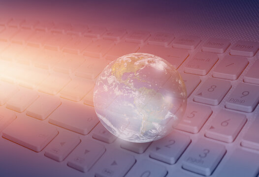 Glass globe on laptop keyboard "Elements of this image furnished by NASA "