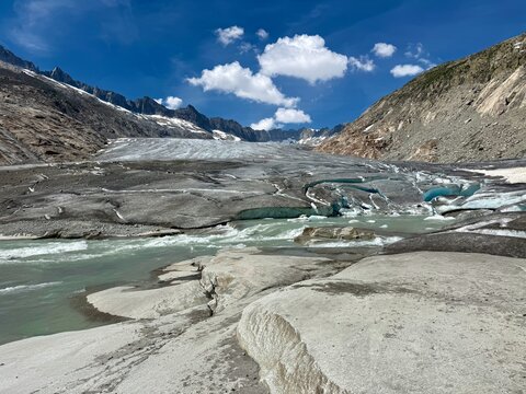 Melting tongue of the Rhone Glacier with blue ice crevasses