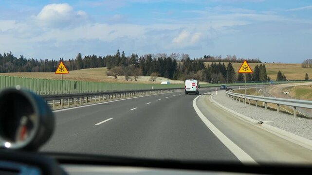 Road trip adventure on a beautiful asphalt highway with mountain landscape.