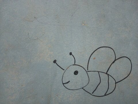 Simple hand drawn cute bee doodle with black marker line art on textured blue background