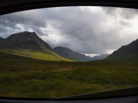Glen coe highlands dramatic light through car window