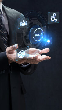 A business professional in a suit holds a glowing digital interface displaying a skills icon and other abstract technology symbols, representing corporate development and talent management