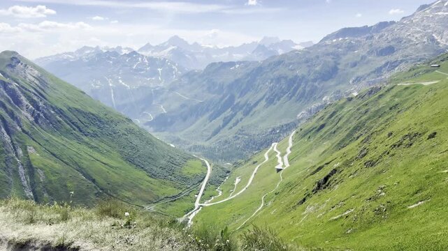 Scenic Furka Pass mountain road winding through a lush green glacial