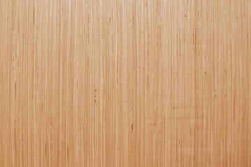 Fototapeta premium Horizontal close up overhead view of a smooth light brown plywood board texture with straight natural wooden grain lines for construction background design